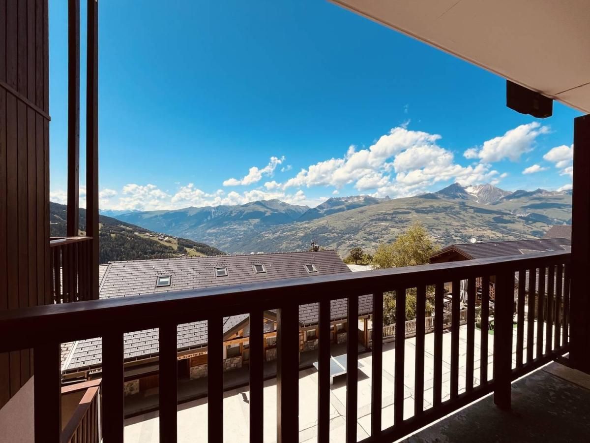 A balcony with a view of a mountainous landscape.