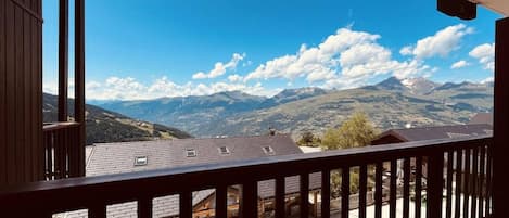 A balcony with a view of a mountainous landscape.
