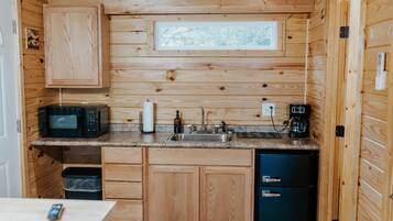Fridge, microwave, coffee/tea maker, cookware/dishes/utensils