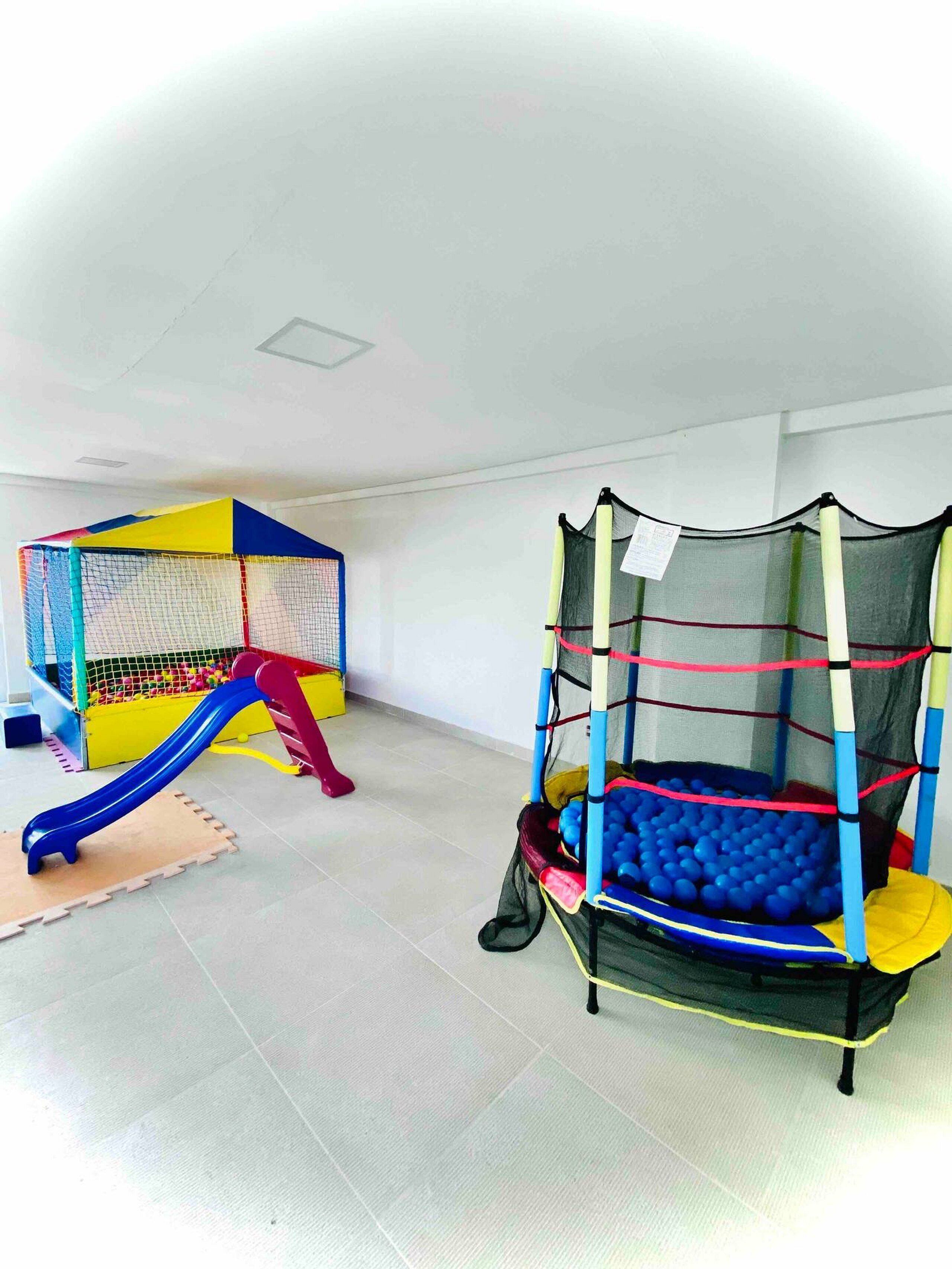 A play area with a slide, a ball pit, and a climbing structure.