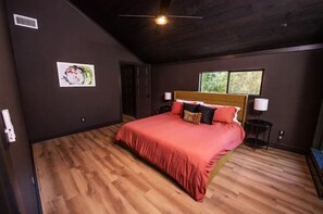 Relax in this serene bedroom with a large bed, two bedside tables, and a window for natural light.
