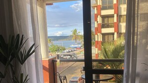 A balcony with a view of a building, a street, and a body of water. - Luxuoso Flat em Reort com vista incrível (Brasília)