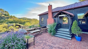 A lodge with a rustic exterior, a chimney, and a sign indicating 'Limantour Lodge Office'.