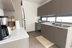 Enjoy cooking in this well-equipped kitchen with an oven, gas stove, and stainless steel sink.