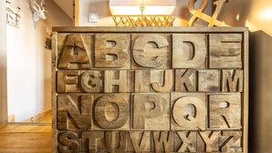 Un'opera d'arte con l'alfabeto in legno, illuminata da una lampada.