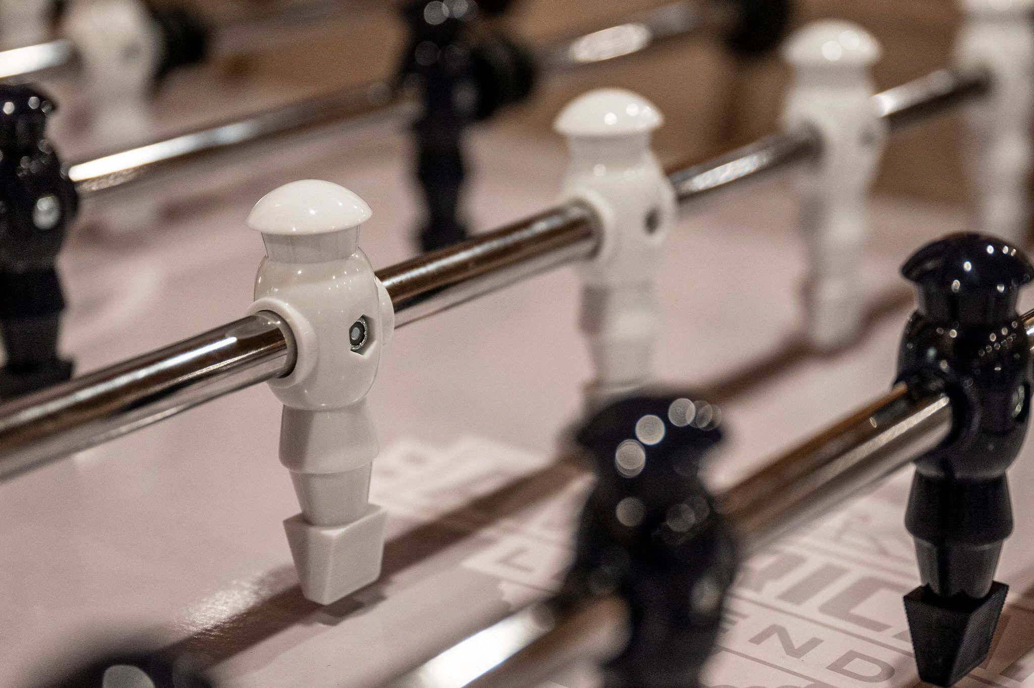 A close-up of a table with a metal bar and black and white fixtures.