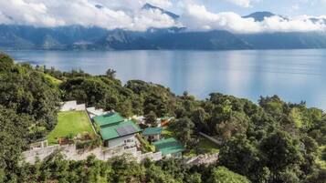 A coastal property with a view of the sea and mountains.
