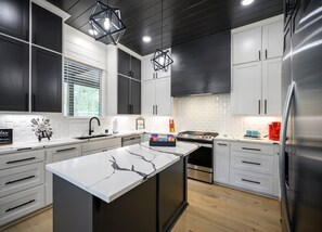 Fridge, microwave, oven, stovetop - Discover Glamping at the Bomasion: Charming Cabin w/ Garage & Fenced Yard (Broken Bow)