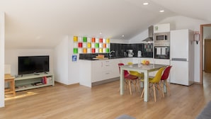 A modern kitchen with white cabinets, a microwave, and a coffee maker. - Vacations in Funchal, sea view - Casa Strelitzia II (Funchal)