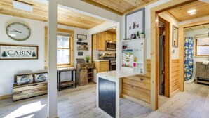 A cabin interior with a kitchen, a dining area, and a living space. - Sugarloaf Vacation Rental ~ 7 Mi to Big Bear Lake! (Sugarloaf)