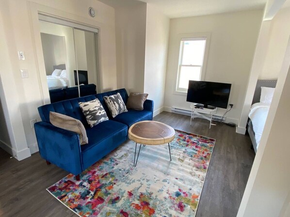 Relax in this stylish living room with a sofa, coffee table, and flat-screen TV.