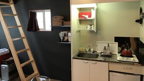A compact kitchen with a built-in sink, a stove, and a small window. - DogrunCafe&Resorts JENNIE West-Karuizawa "Pigu" is perfect for groups and family trips! Pet Friendly Hotels (Miyota, Kitasaku District)