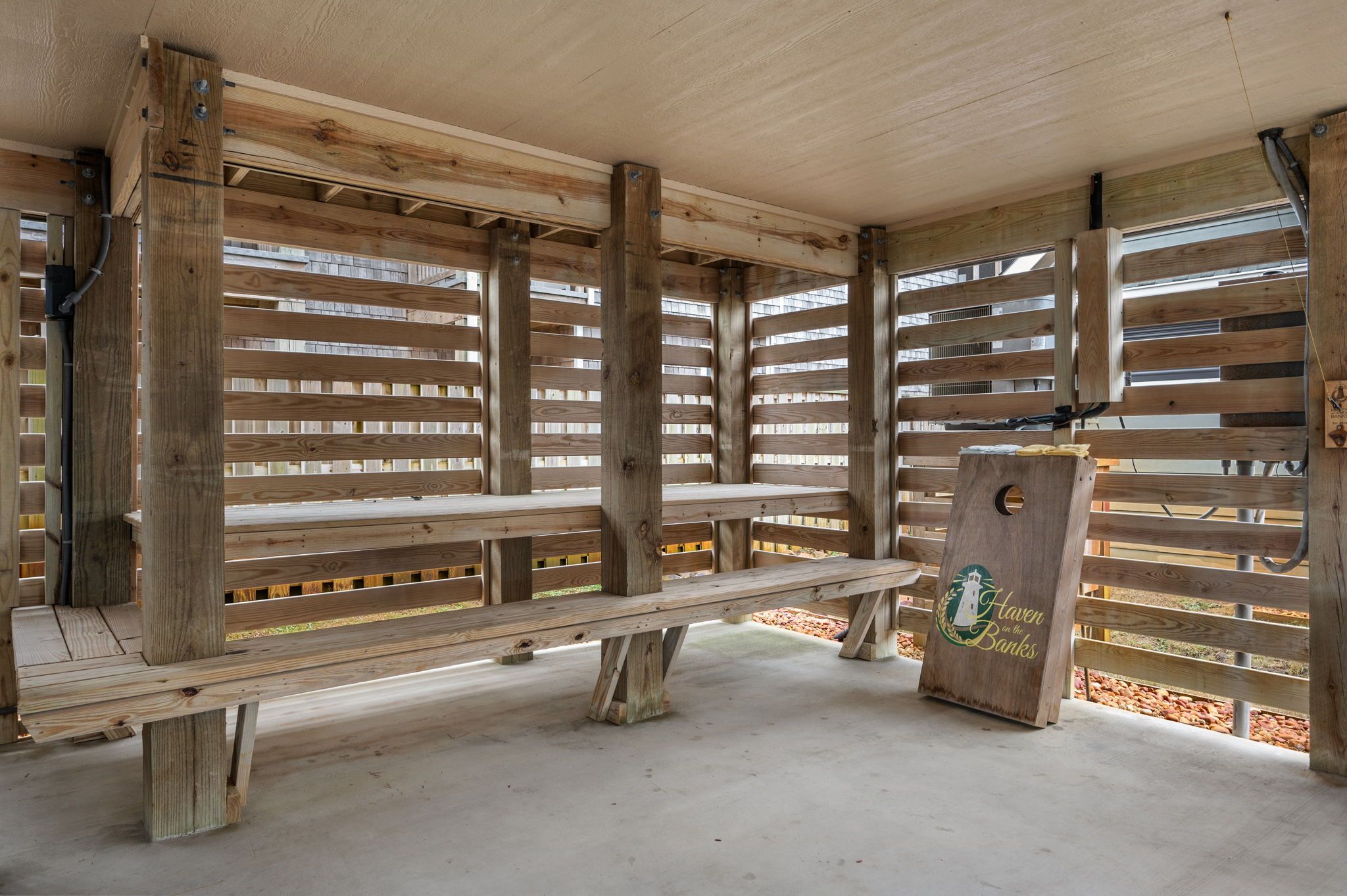 A wooden bench area with a sign reading 'Haven on the Banks.'