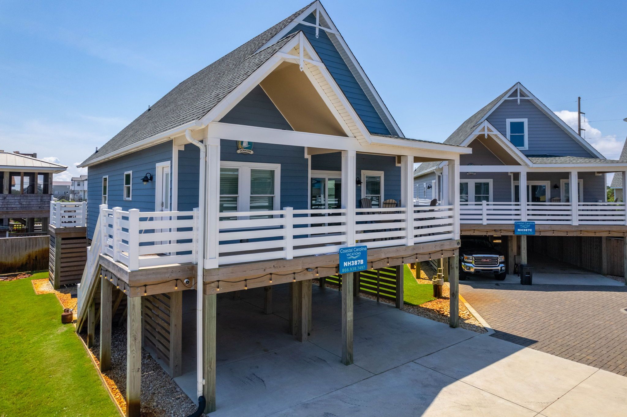 A coastal building with a balcony, a covered area, and a garage.