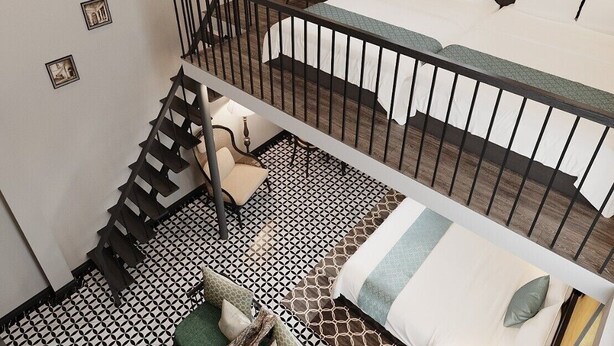 A two-level room with a staircase, a bed, a desk, and a window. - Dai Thuy Hotel (Hai Phong)