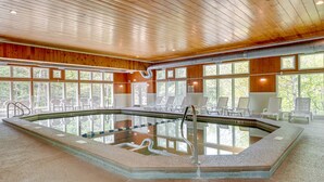 An indoor swimming pool with wooden paneling and large windows. - Inviting Bartlett Condo: 1 Mi to Attitash Mountain (Bartlett)