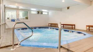 A swimming pool with a metal safety rail, wooden deck, and a sign indicating hot tub control. - Inviting Bartlett Condo: 1 Mi to Attitash Mountain (Bartlett)
