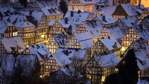 A cluster of traditional half-timbered houses with snow-covered roofs, likely in a historic European town. - Flecker Hotel (Freudenberg)