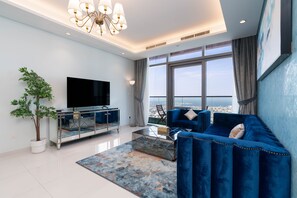 Panoramic Apartment | Living area | 60-inch Smart TV with digital channels, Netflix, streaming services - Lux BnB Paramount Midtown I Ocean View (Dubai)