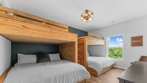 A room with bunk beds, a desk, and a window with a view. - Outdoor Theater, HotTub, Pool, Pickleball, Slps 24 (Kimberling City)