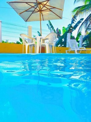 Outdoor pool, open 10:00 AM to 8:00 PM, pool umbrellas, pool loungers