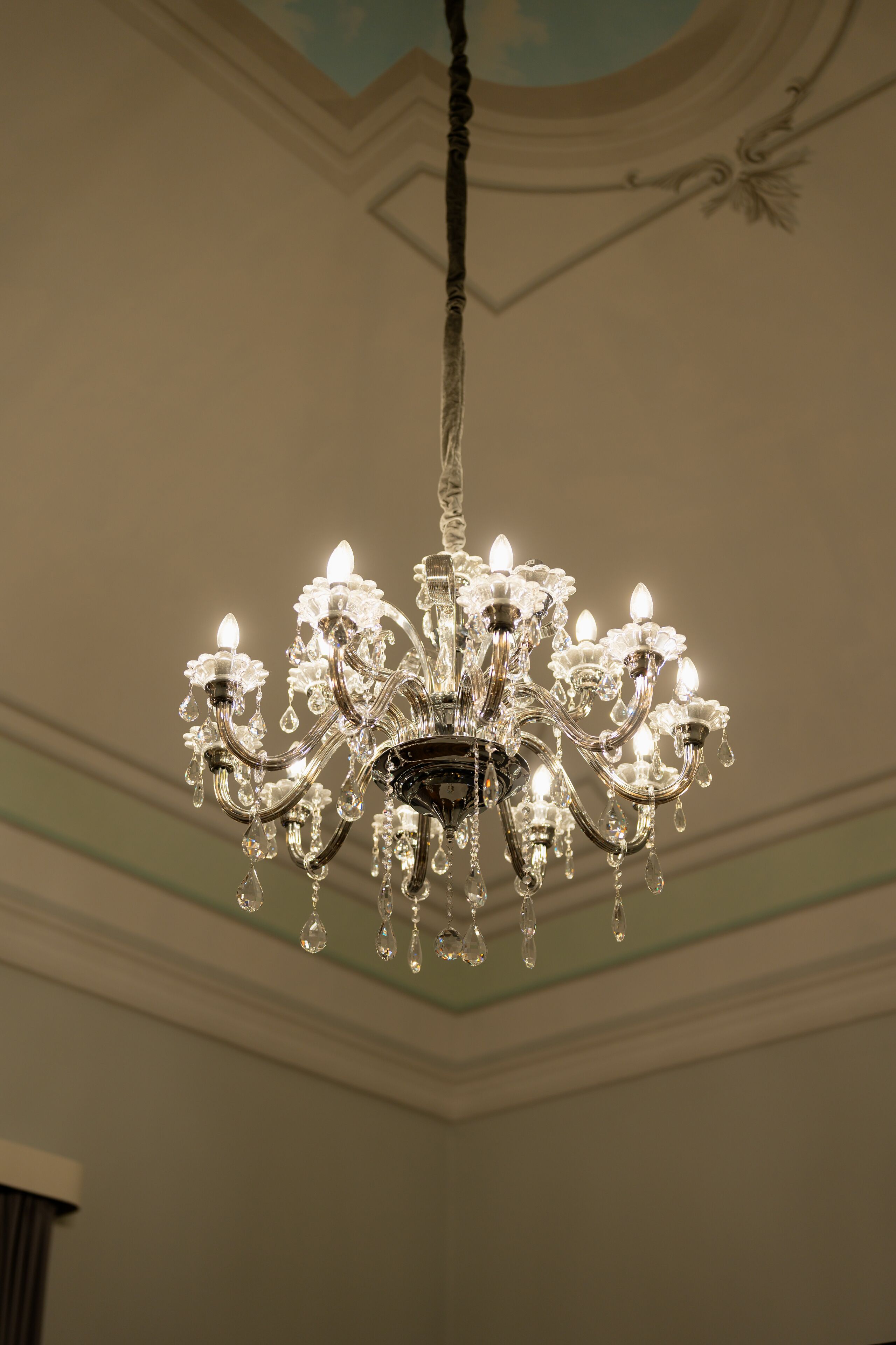 A chandelier with multiple arms and crystal decorations.