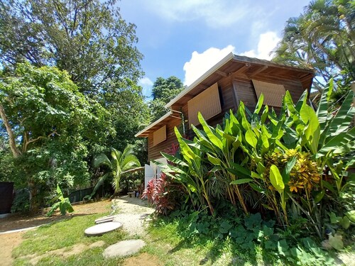 Chalet with jungle view deck on a river in lively Santa Teresa's surf town