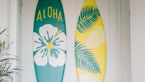 Two surfboards with floral designs on a staircase. - Casa Amarta Canggu - Boutique Loft & Detox Spa (Canggu)