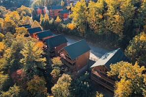 A lodge with multiple buildings surrounded by dense forest.