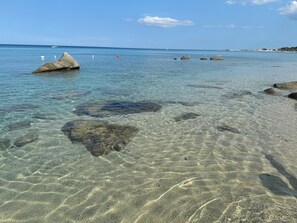 A clear beach with visible rocks and calm water. - Galliano 51. Holiday in Style – City Center (Soverato)
