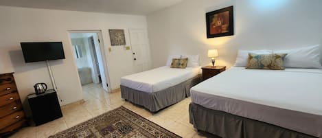Basic Quadruple Room | Minibar, blackout drapes, iron/ironing board (on request), WiFi (free)