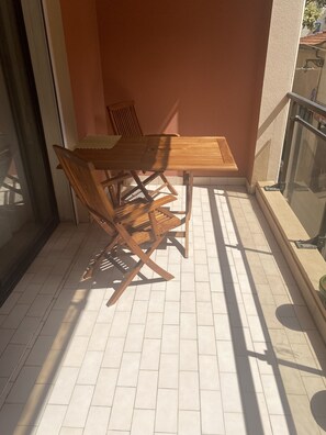 Enjoy a quiet moment in this outdoor space with a table and chairs.