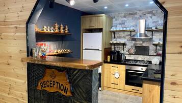 A kitchen with wooden cabinets, a stove, and a refrigerator.