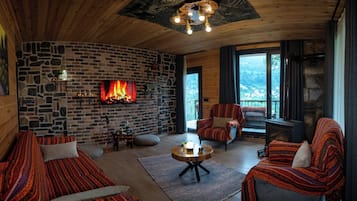 Family Bungalow | Living area | 70-inch LCD TV with satellite channels, tablet, books