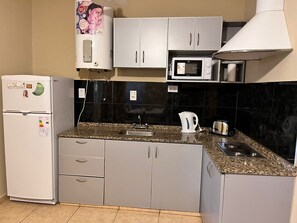 Fridge, microwave, stovetop, coffee/tea maker