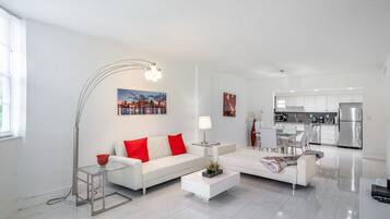 Luxury Suite | Living area | 40-inch flat-screen TV with cable channels