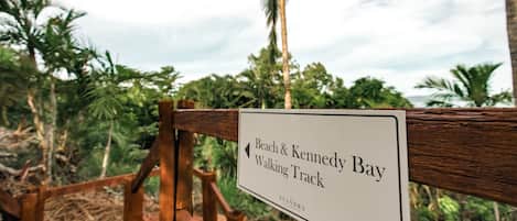 A sign for the Beach & Kennedy Bay Walking Track.