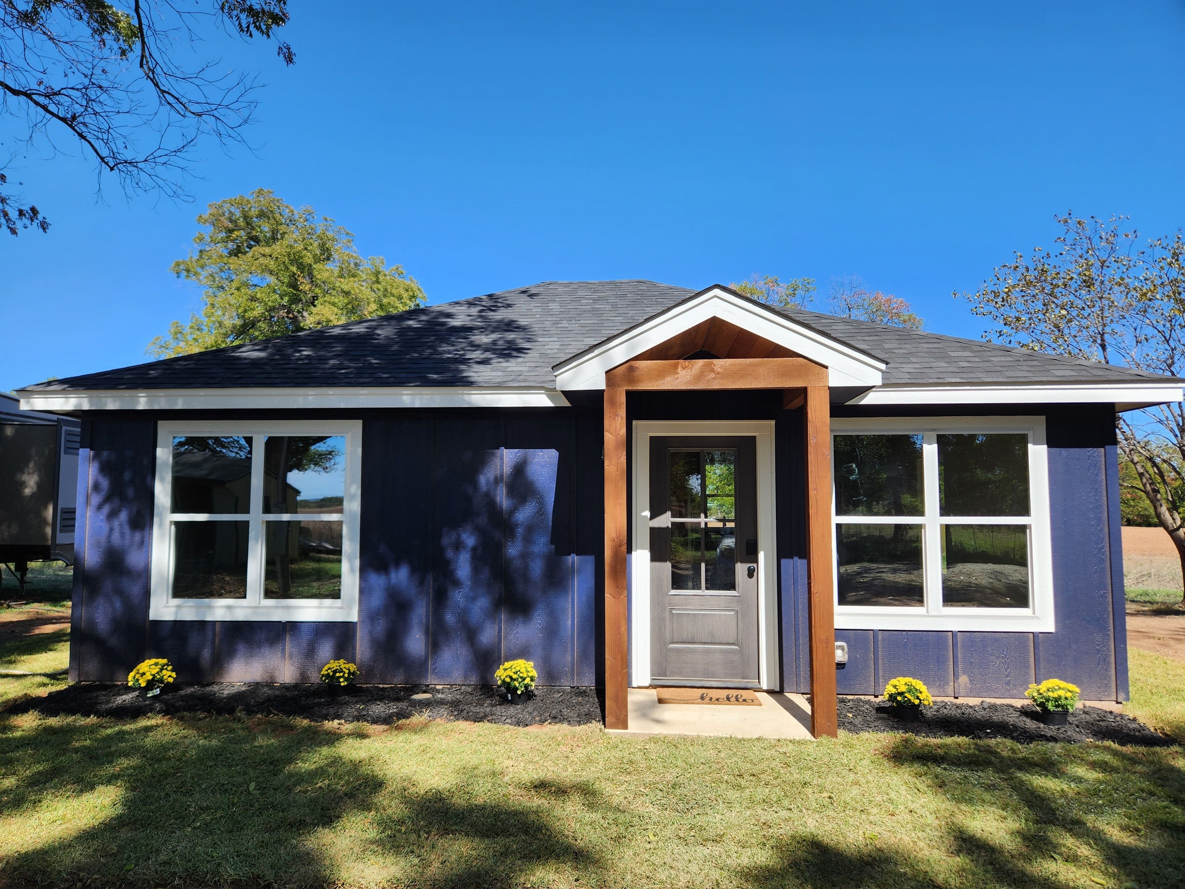 Modern-style cabin, located in rustic farmland near Bend, TX.