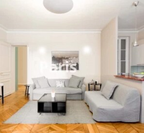 A spacey elegant and relaxing living room, equipped with a relaxing sofa bed