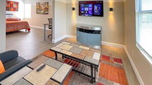 Relax in this stylish living space with a flat-screen TV and comfortable sofa.