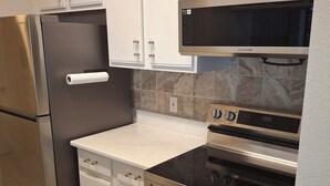 A modern kitchen with stainless steel appliances, white cabinetry, and a marble backsplash. - 1st Floor Condo,  $85 OctNovDec. Sleeps 4. renovated.
The Avalon at Clearwater

 (Clearwater)
