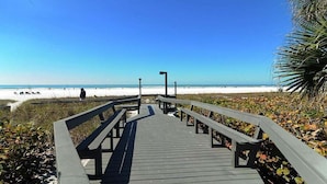 A wooden boardwalk leading to a beach with a clear sky. - Lakefront Siesta Key condo with beach access - GBB 1313 (Sarasota)