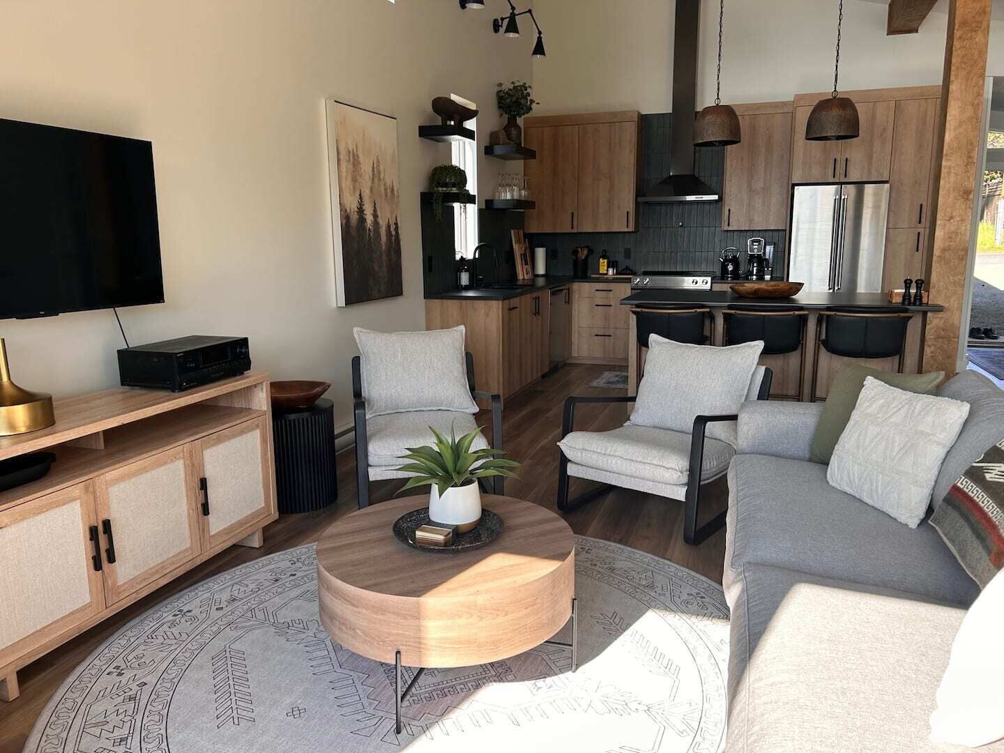 A modern living room with a TV, sofa, and coffee table.