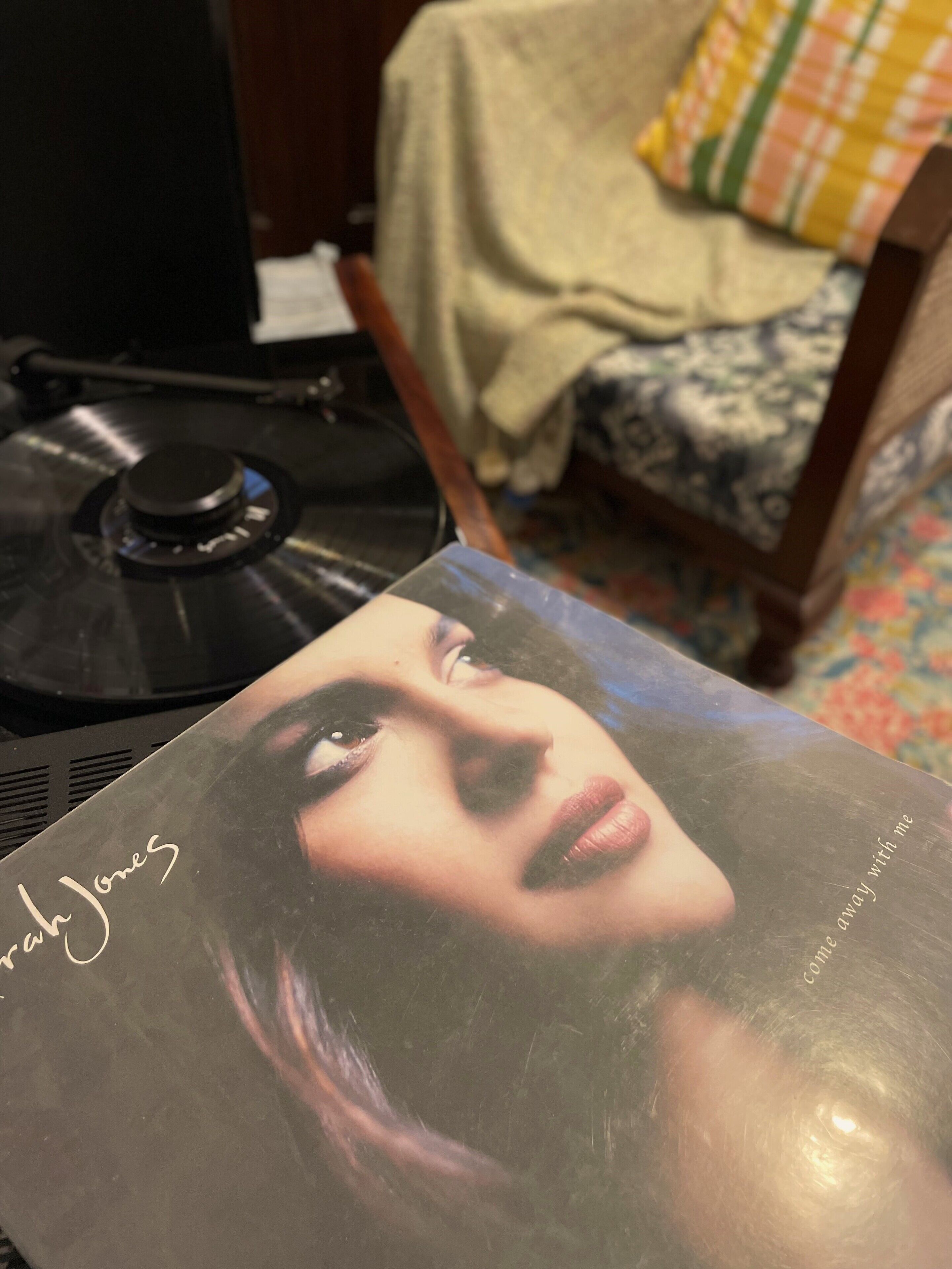 A vinyl record and a CD cover with a person's face on it.