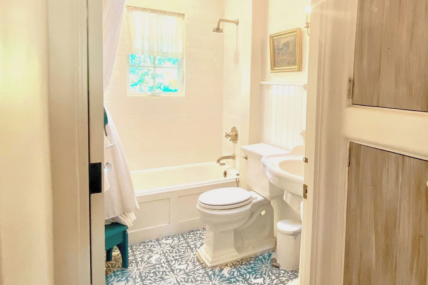 A bathroom with a bathtub, toilet, and sink.