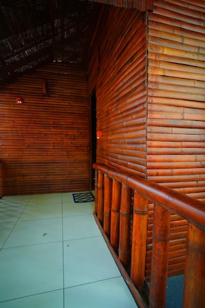 A room with a tiled floor, wooden walls, and a visible door. - MISTY MORNING RESORT (Sulthan Bathery)
