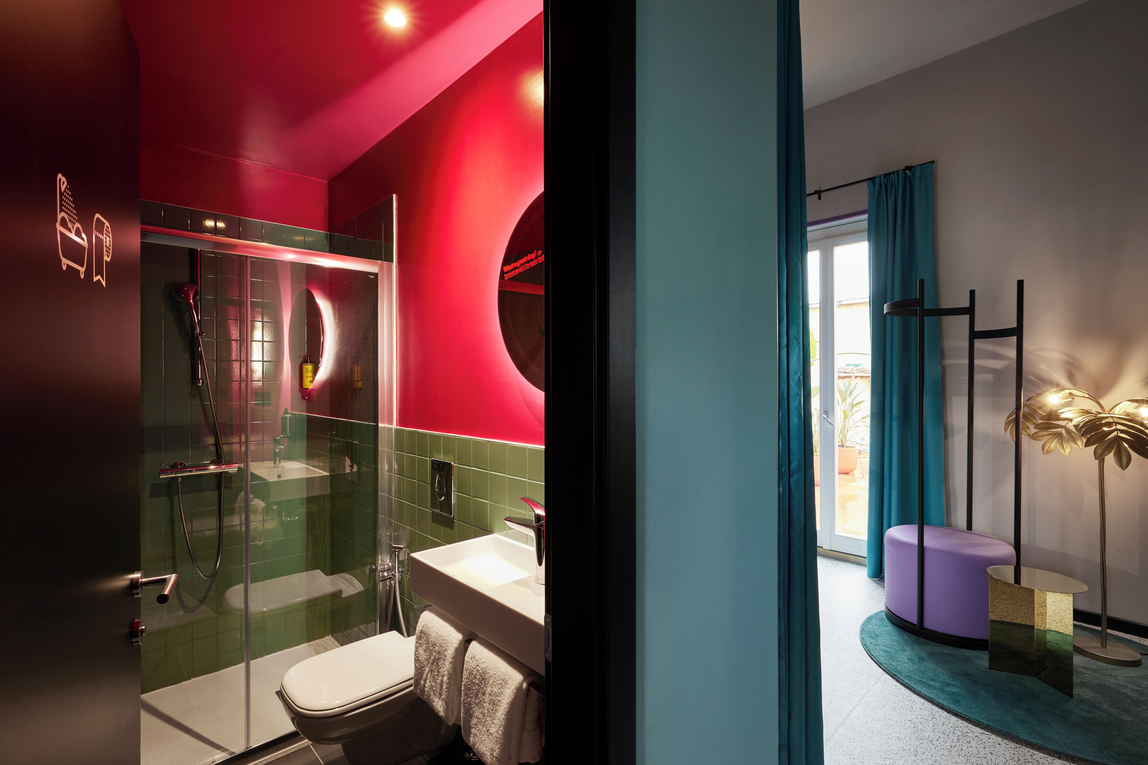 A modern bathroom with a glass-enclosed shower, a white sink, and a toilet.