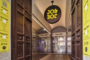 A corridor with a 'Breakfast' sign, a 'Lunch Buffet' sign, and a 'Happy Hour' sign.