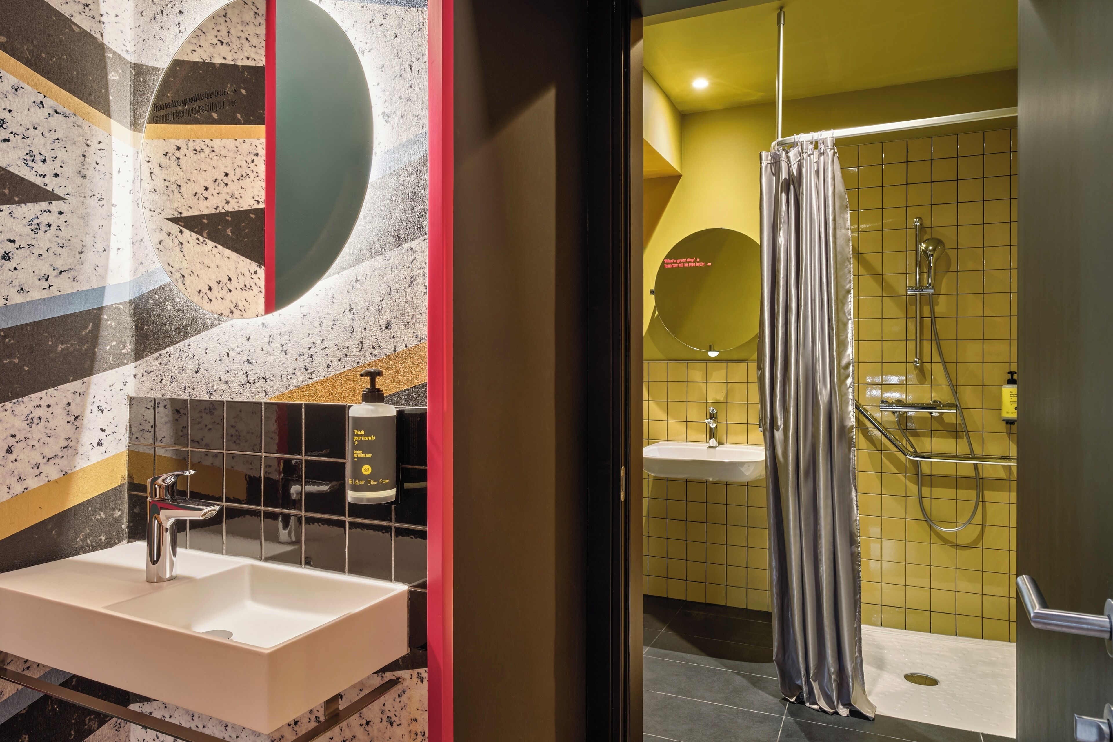 A bathroom with a white sink, a mirror, and a shower area with a curtain.