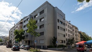 A multi-story building with a modern architectural style, featuring balconies and large windows. - Nest - Riehenring (Basel)